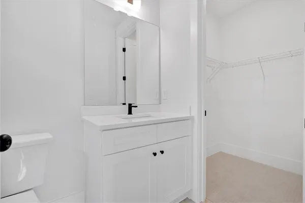 a bathroom with a sink a toilet and mirror