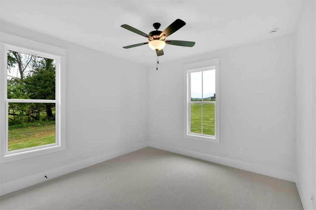 300 Eminence Peak Rydal, GA 30171 - Photo 38 of 46 an empty room with window and ceiling fan