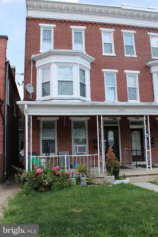 a front view of brick house with a yard