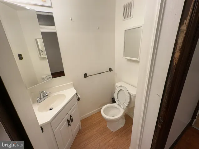 a bathroom with a sink a toilet and a mirror