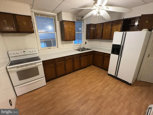 a kitchen with a stove a refrigerator and a microwave