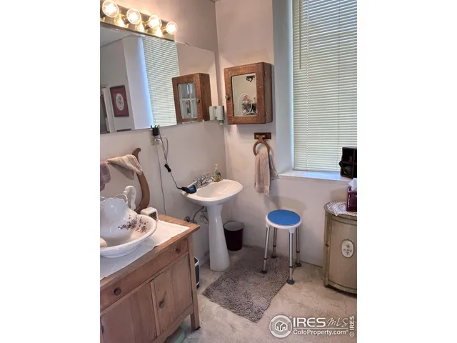 a bathroom with a sink toilet and mirror
