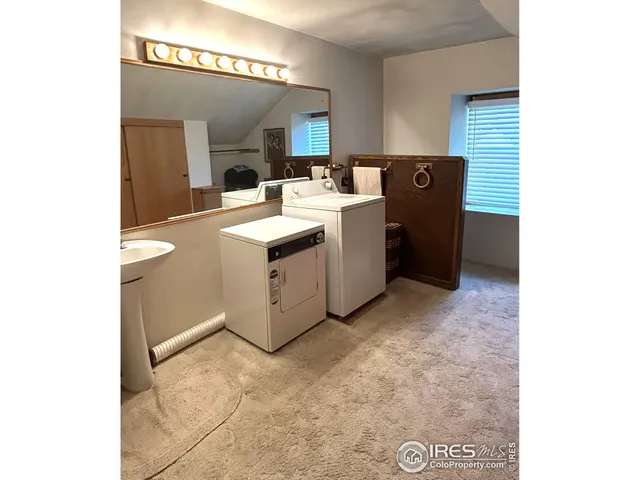 a utility room with sink dryer and washer