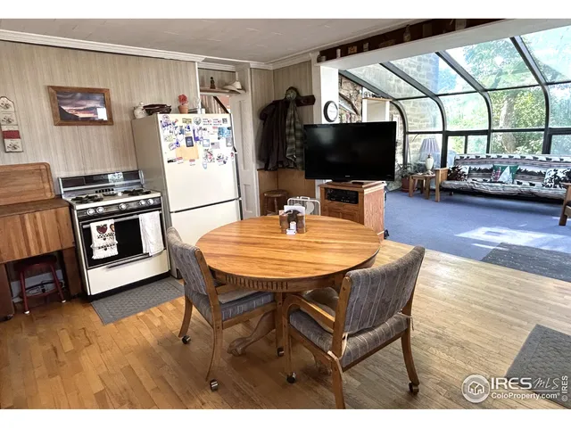 a dining room with furniture and wooden floor