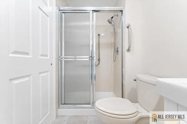 a white toilet sitting next to a bathroom sink