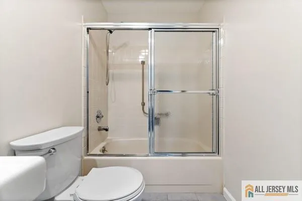 a white toilet next to a bathroom sink