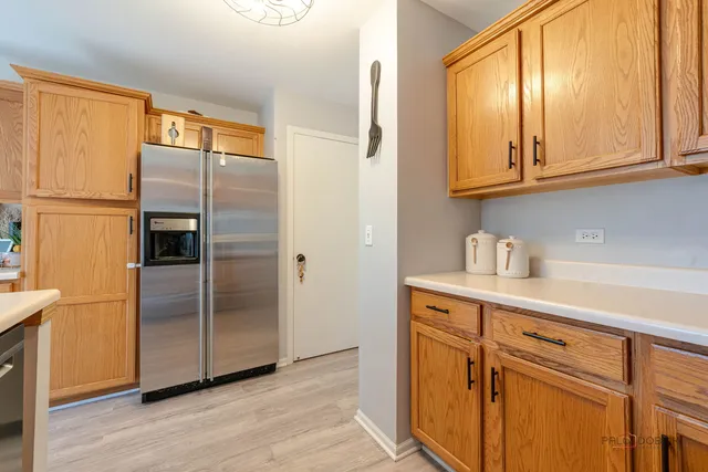 a kitchen with stainless steel appliances granite countertop a refrigerator and a stove top oven