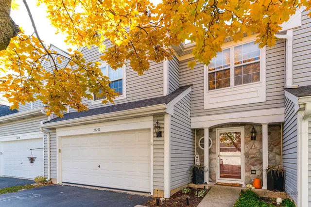 a front view of a house with garage