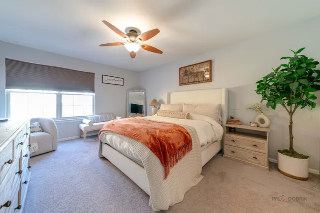 a spacious bedroom with a bed and a chandelier