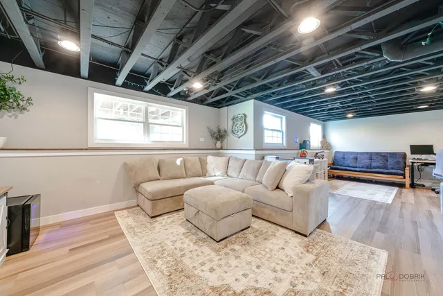 a living room with furniture and wooden floors