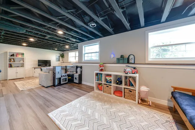 a room with lots of wooden furniture and a kitchen view