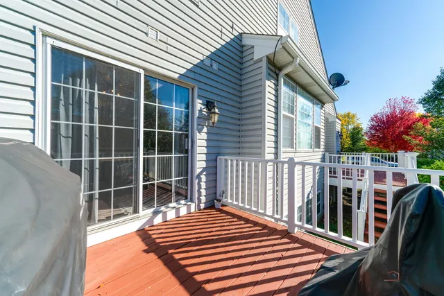 a backyard of a house with wooden floor and fence