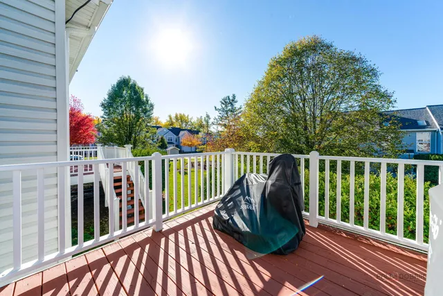 a balcony with wooden floor and outdoor space