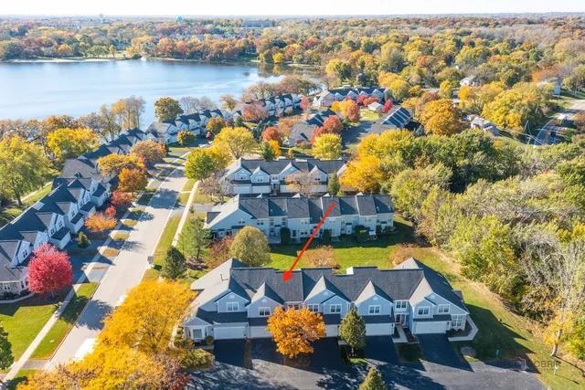 an aerial view of residential houses with outdoor space and swimming pool