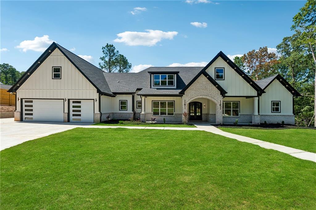a view of a yard in front of a house with large trees