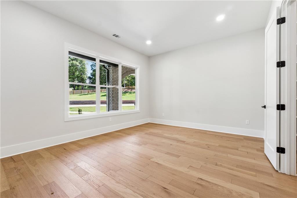 1622 Double Springs Monroe, GA 30656 - Photo 16 of 40 a view of an empty room with wooden floor and a window
