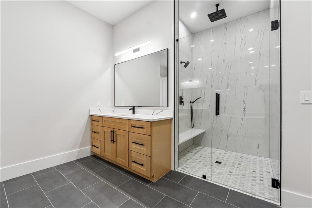 1622 Double Springs Monroe, GA 30656 - Photo 20 of 40 a bathroom with a shower sink and mirror