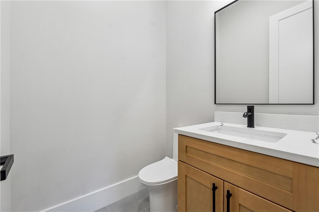 1622 Double Springs Monroe, GA 30656 - Photo 31 of 40 a bathroom with a granite countertop toilet sink and mirror