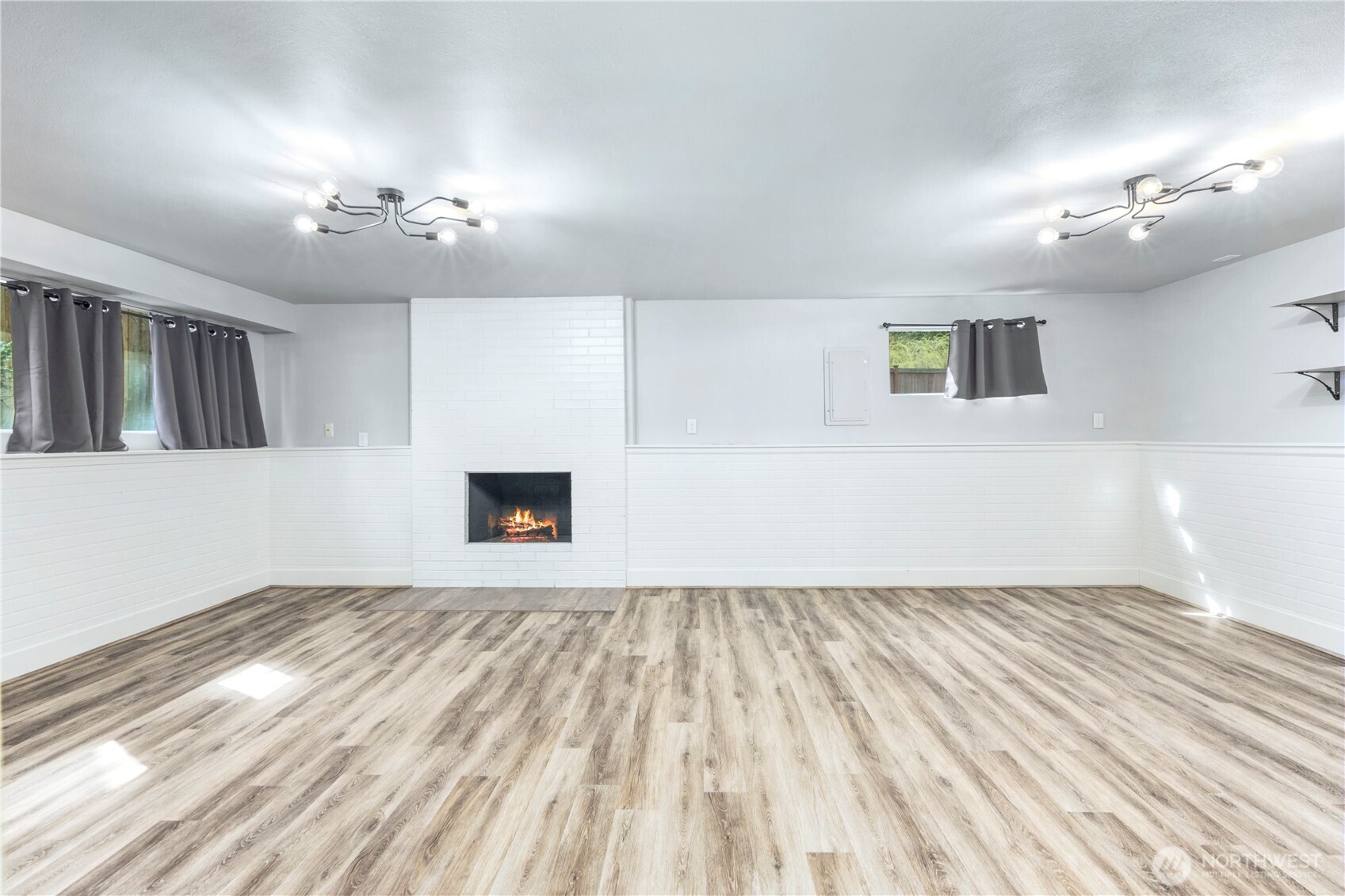 9 216th Street Southeast Bothell, WA 98021 - Photo 19 of 28 an empty room with wooden floor and windows