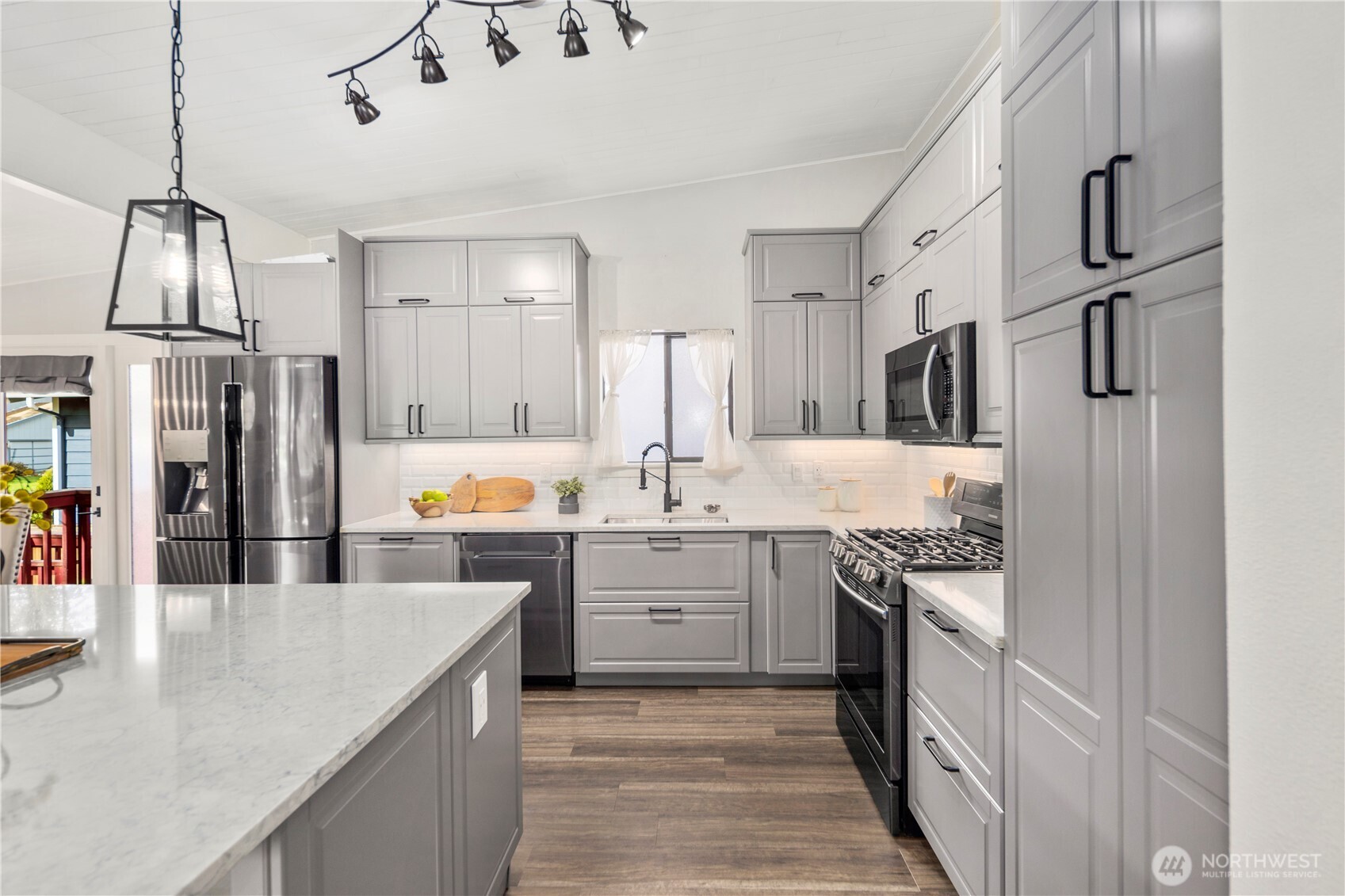 9 216th Street Southeast Bothell, WA 98021 - Photo 10 of 28 a kitchen with stainless steel appliances granite countertop a sink and cabinets