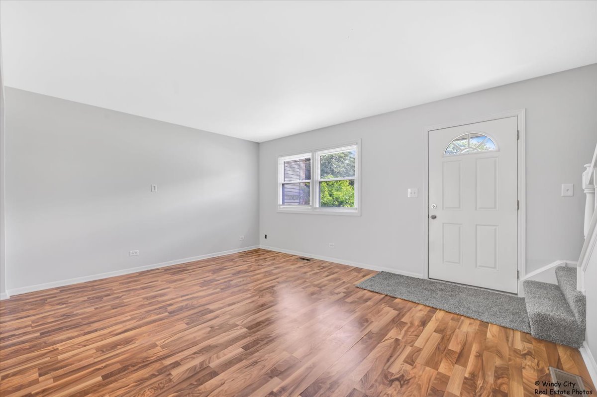 936 Cardiff Court Schaumburg, IL 60169 - Photo 11 of 35 a view of empty room with wooden floor