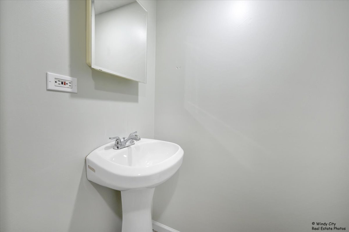 936 Cardiff Court Schaumburg, IL 60169 - Photo 12 of 35 a bathroom with a sink and a mirror