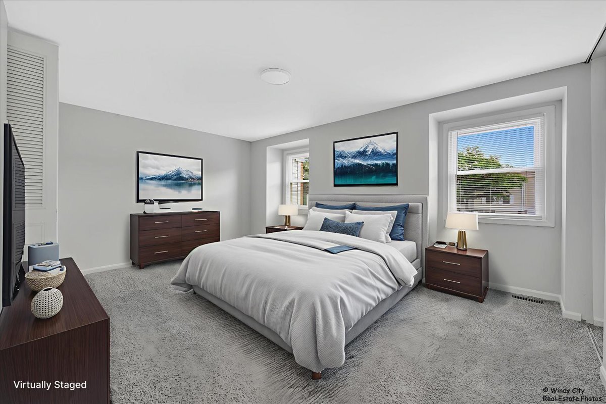 936 Cardiff Court Schaumburg, IL 60169 - Photo 14 of 35 a spacious bedroom with a bed a couch and a window