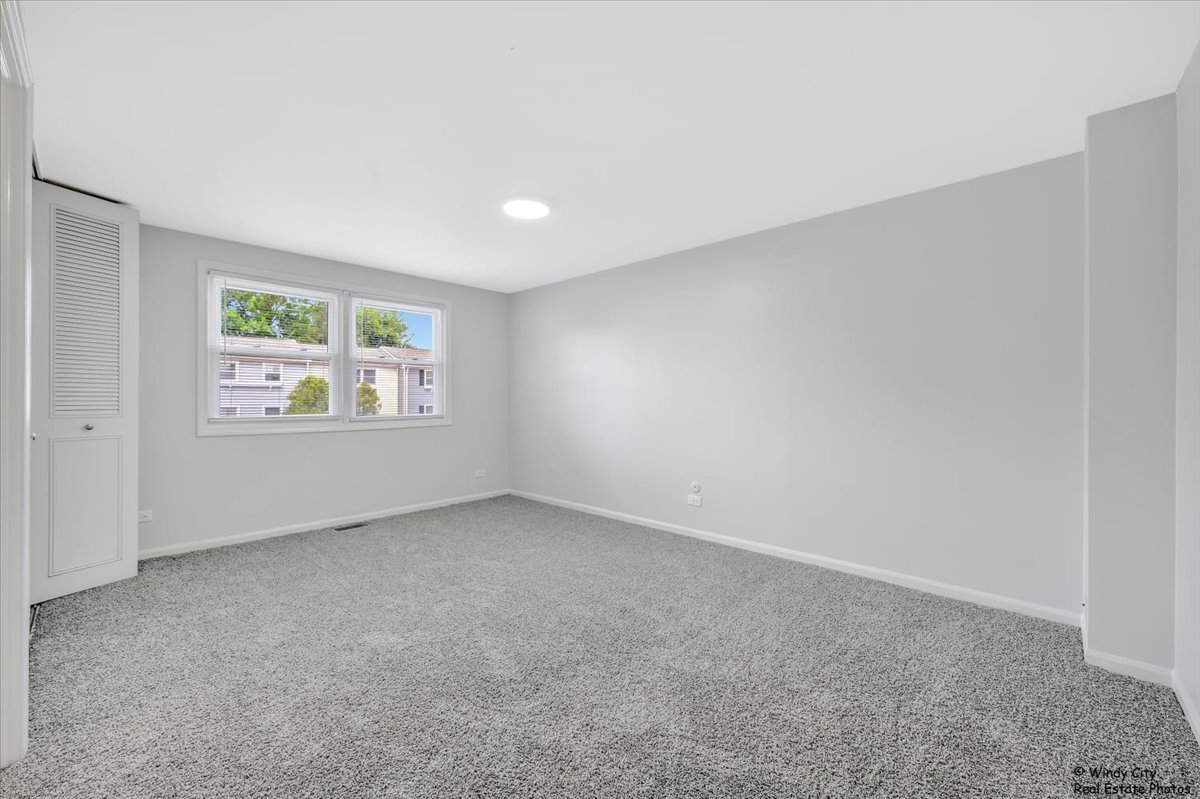 936 Cardiff Court Schaumburg, IL 60169 - Photo 16 of 35 an empty room with windows