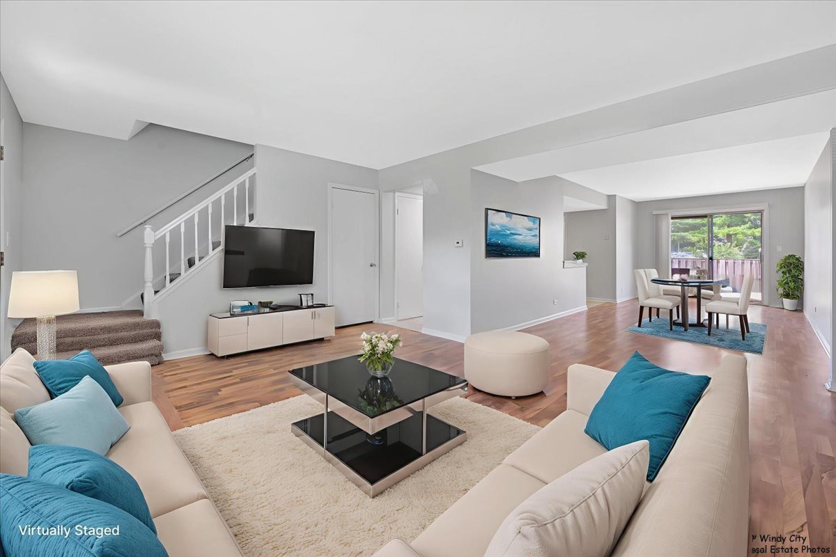 936 Cardiff Court Schaumburg, IL 60169 - Photo 3 of 35 a living room with furniture and a flat screen tv