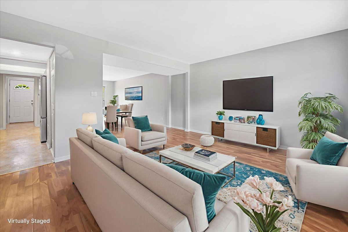 936 Cardiff Court Schaumburg, IL 60169 - Photo 9 of 35 a living room with furniture a flat screen tv and a dining table