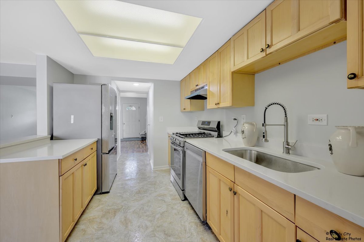 936 Cardiff Court Schaumburg, IL 60169 - Photo 10 of 35 a kitchen with sink a stove and cabinets