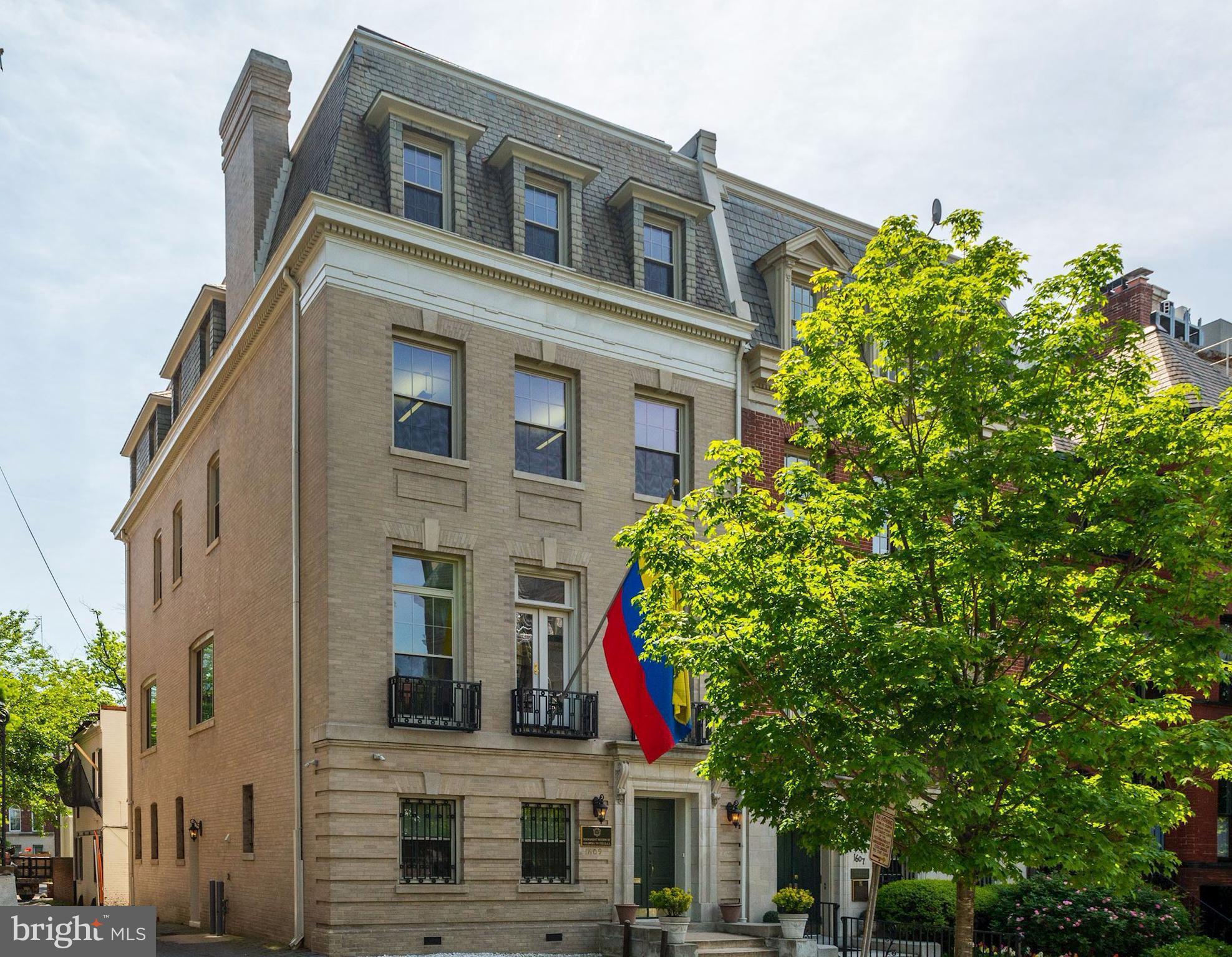 a front view of a house with a tree