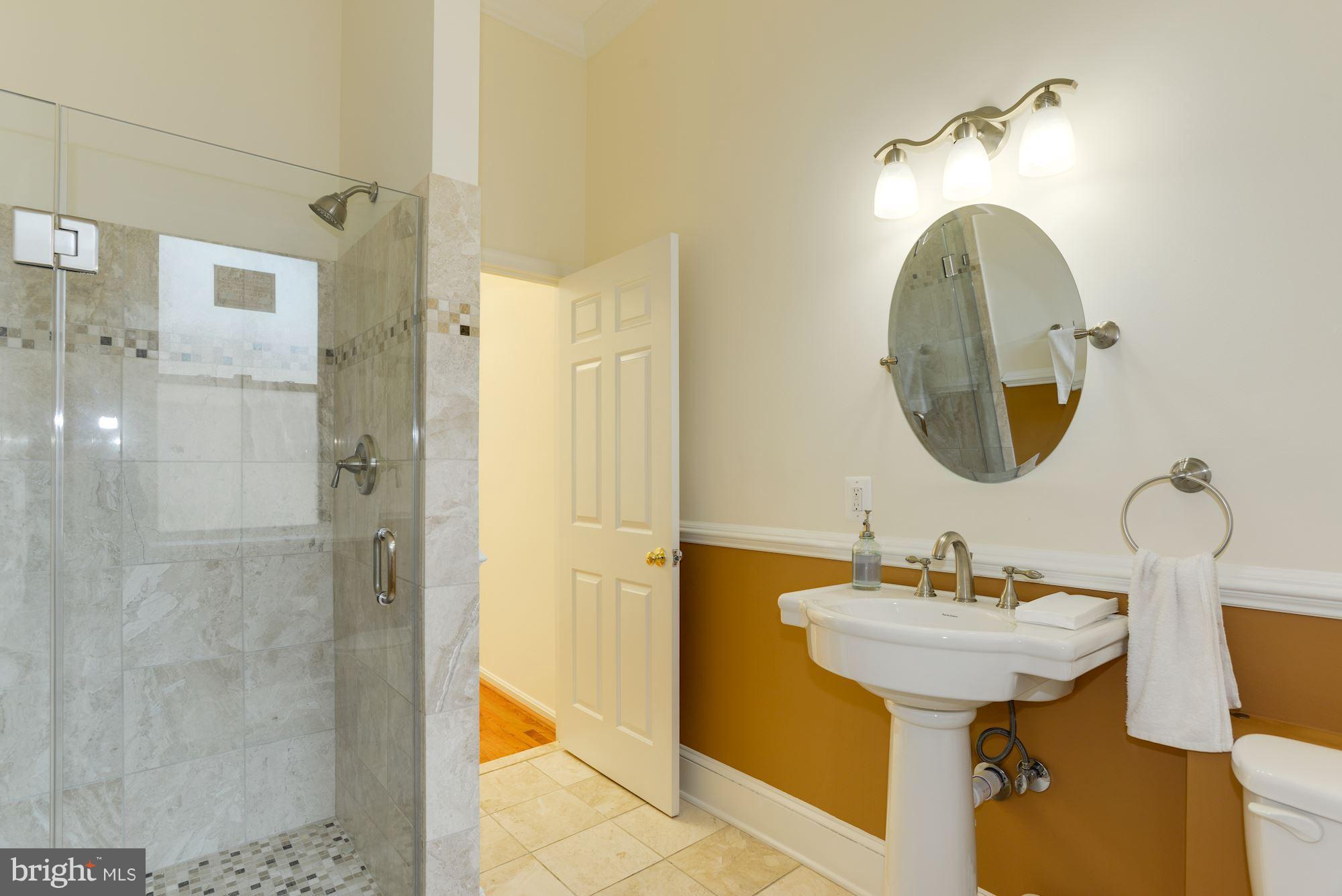 1609 22nd Street Northwest Washington, DC 20008 - Photo 11 of 24 a bathroom with a sink a mirror and a shower