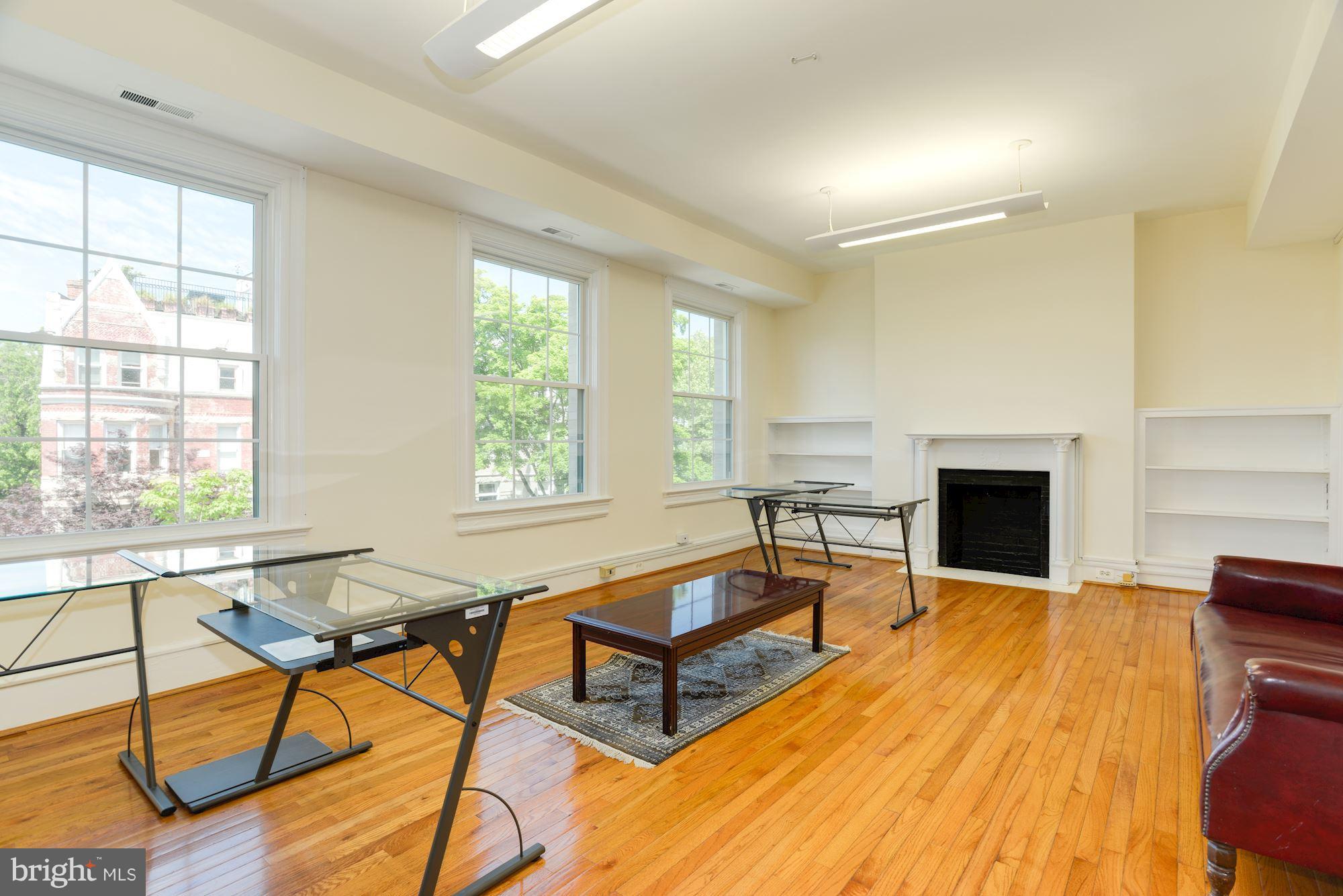 1609 22nd Street Northwest Washington, DC 20008 - Photo 14 of 24 a living room with furniture a fireplace and large windows