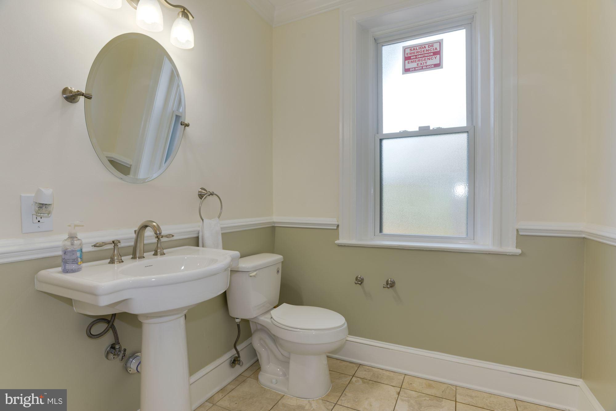1609 22nd Street Northwest Washington, DC 20008 - Photo 16 of 24 a bathroom with a toilet sink and mirror