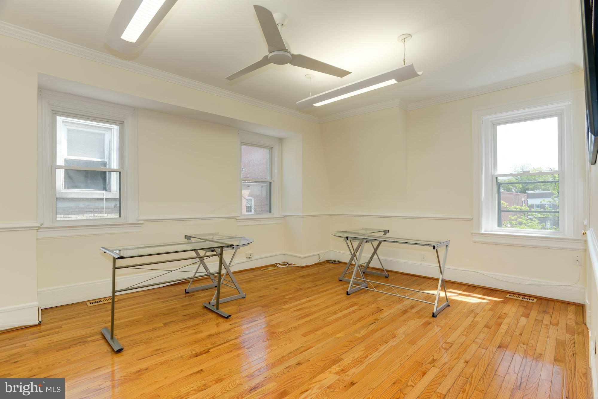 1609 22nd Street Northwest Washington, DC 20008 - Photo 19 of 24 a view of a room with wooden floor and chairs
