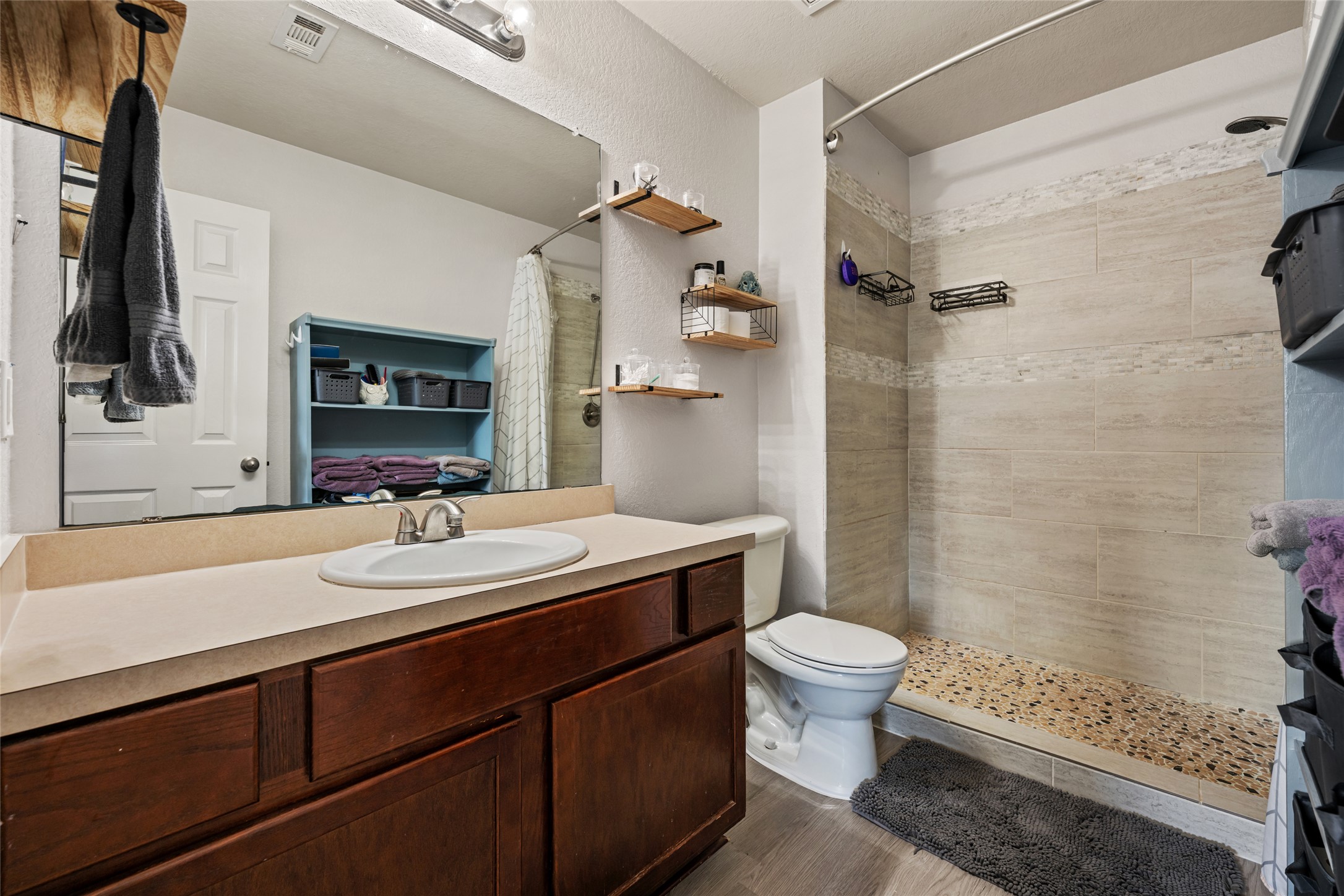 144 Calcite Lane Jarrell, TX 76537 - Photo 22 of 38 A sleek, contemporary bathroom featuring a spacious walk-in shower and ample vanity storage.