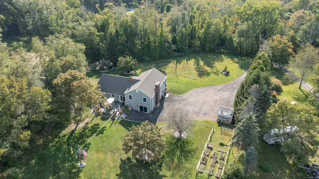 an aerial view of a house with a yard basket ball court and outdoor seating