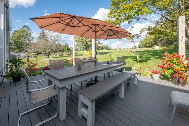 a view of a patio with furniture and yard