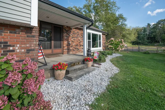 a view of a backyard with sitting area and garden