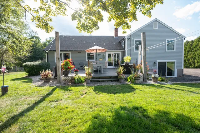a view of a house with a yard porch and sitting area