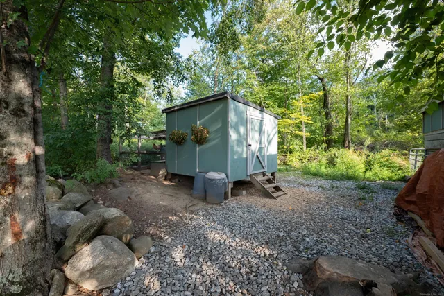 a bedroom with a bed a flat screen tv and a couch