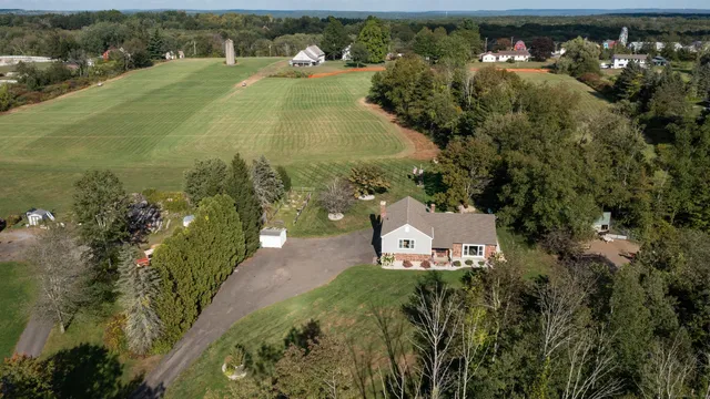 an aerial view of a house with a yard and lake view