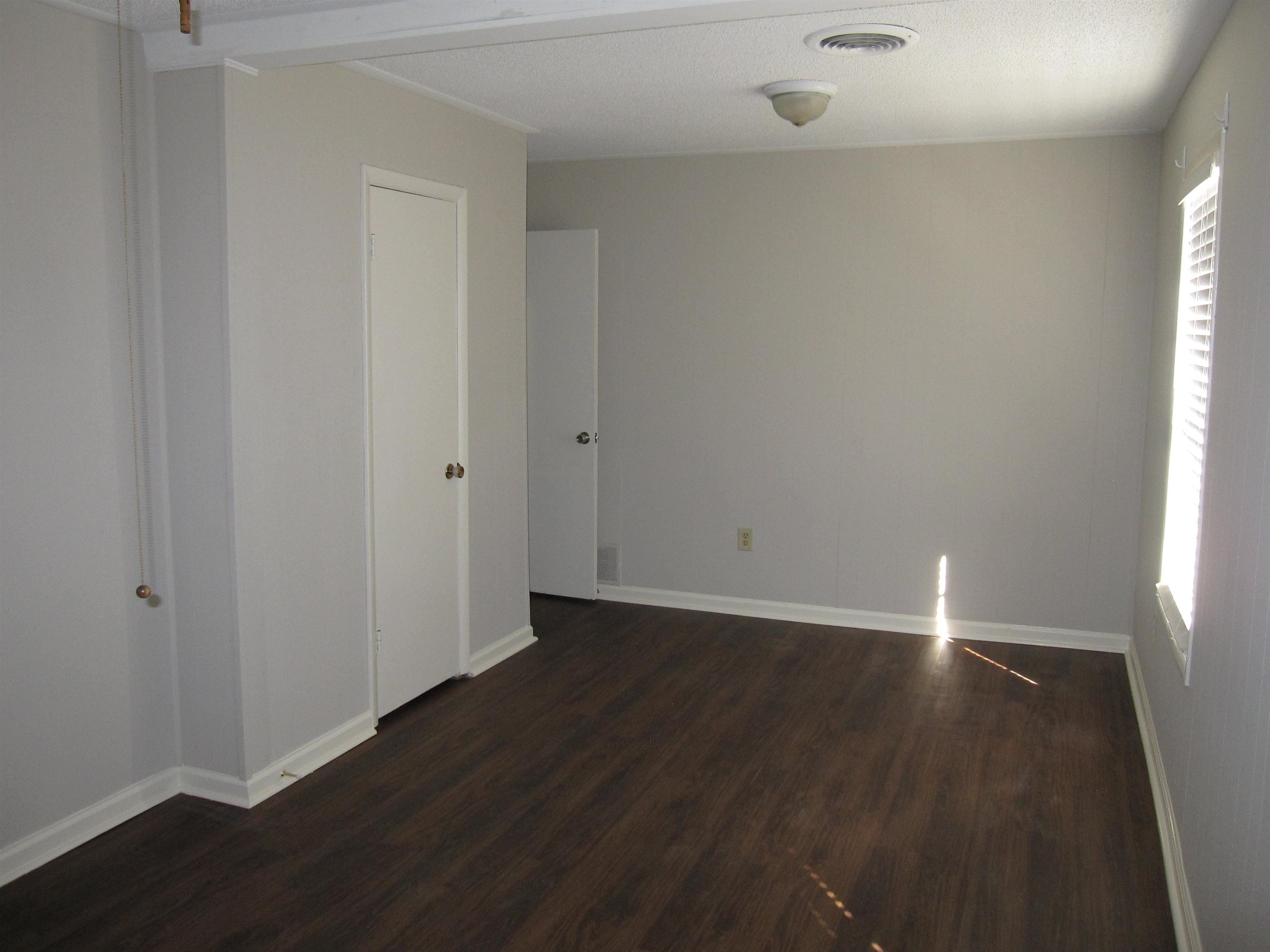 935 Poplar Leaf Road Collierville, TN 38017 - Photo 15 of 19 a view of an empty room with wooden floor and a window
