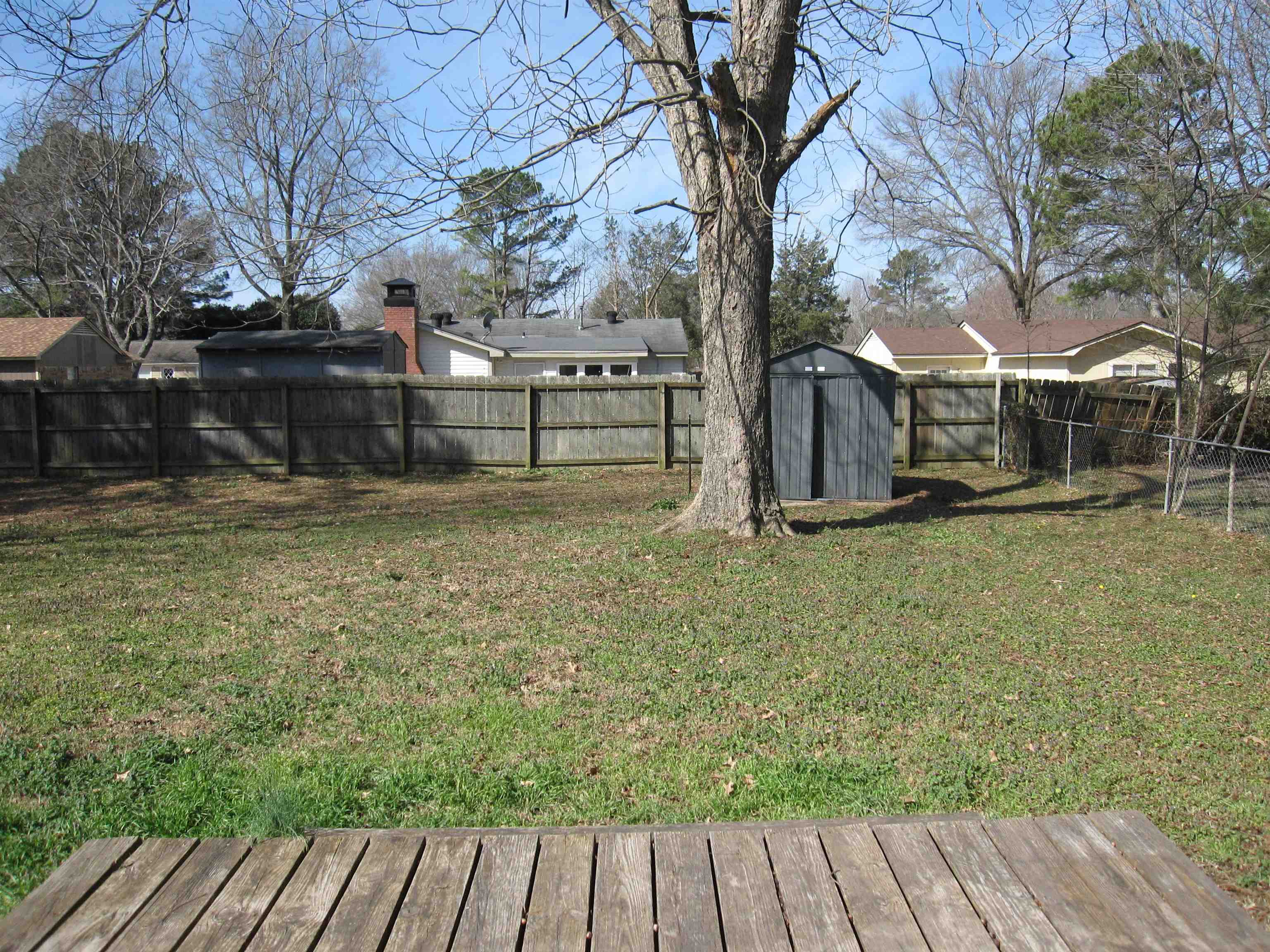 935 Poplar Leaf Road Collierville, TN 38017 - Photo 18 of 19 a view of a backyard with wooden fence