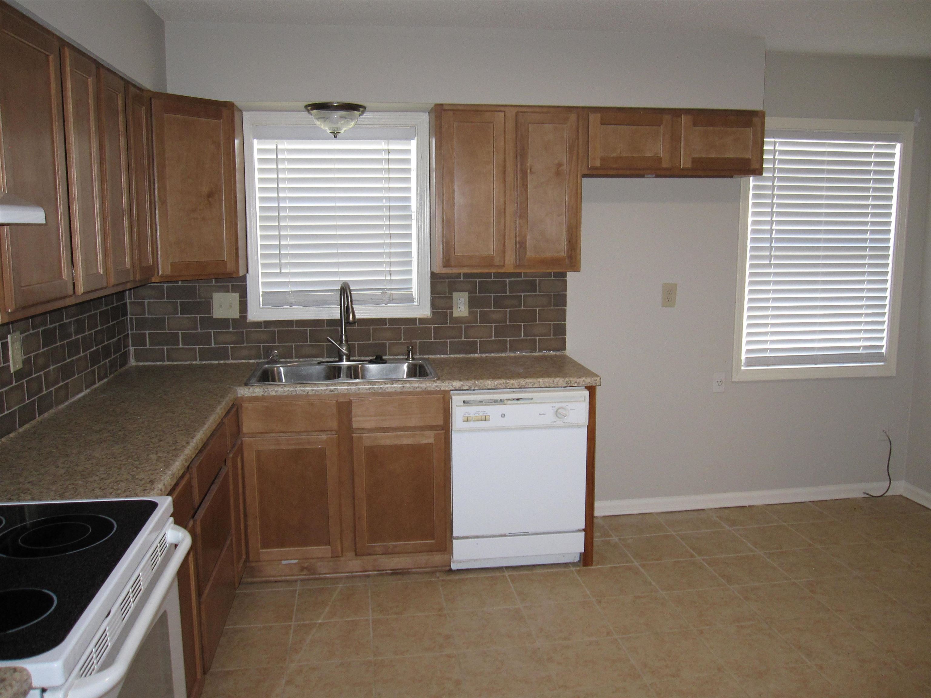 935 Poplar Leaf Road Collierville, TN 38017 - Photo 3 of 19 a kitchen with a sink stove and cabinets