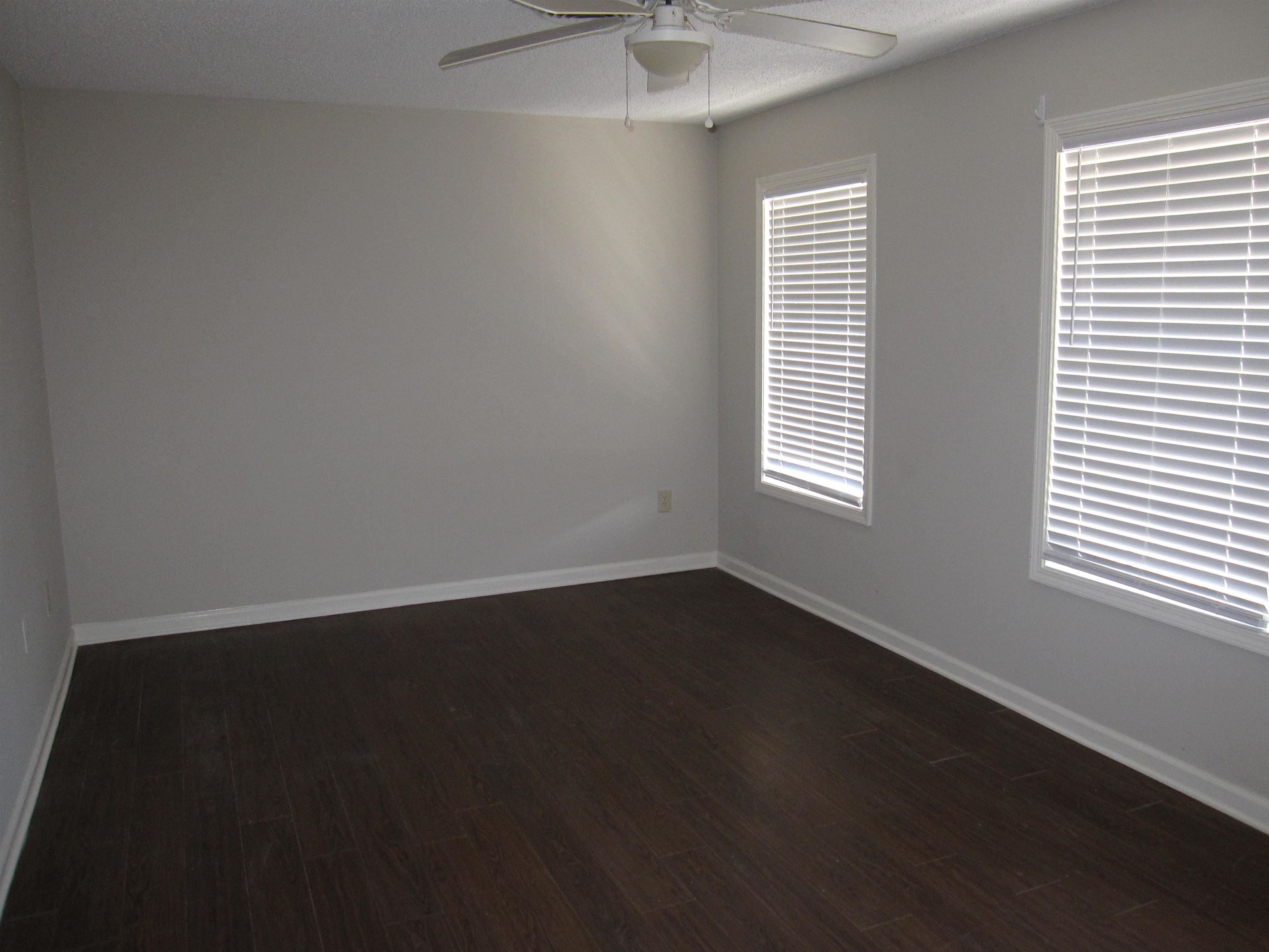 935 Poplar Leaf Road Collierville, TN 38017 - Photo 6 of 19 an empty room with wooden floor and windows