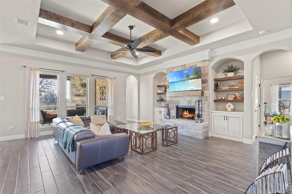 a living room with fireplace furniture and a wooden floor