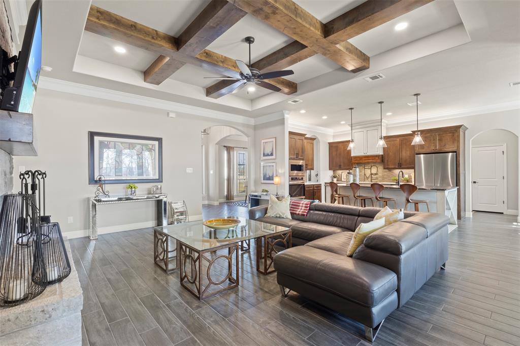 703 Winkler Way Springtown, TX 76082 - Photo 12 of 37 a living room with furniture kitchen view and a wooden floor