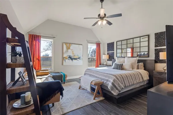 a bedroom with a bed a couch and a chandelier